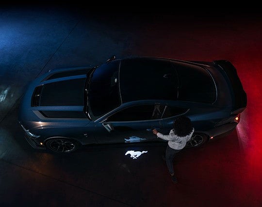 2024 Ford Mustang® Dark Horse™ model with a driver approaching the vehicle | Soeby Motor Company in Walhalla ND