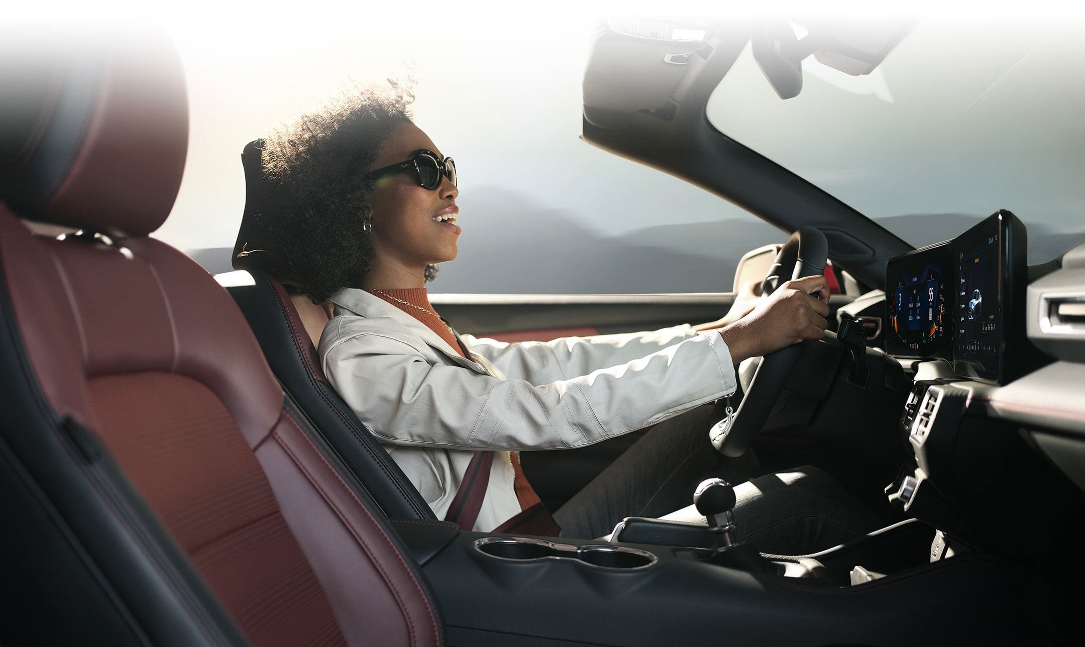 Person sitting in the driver’s seat of a 2024 Ford Mustang® convertible | Soeby Motor Company in Walhalla ND